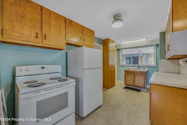 kitchen with backsplash, sink, and white appliances