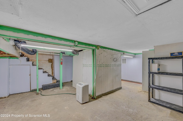 basement with a textured ceiling