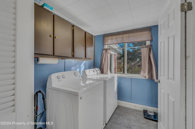 laundry room featuring cabinets and washer and clothes dryer