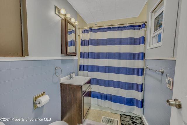 bathroom featuring a shower with curtain, vanity, and tile walls