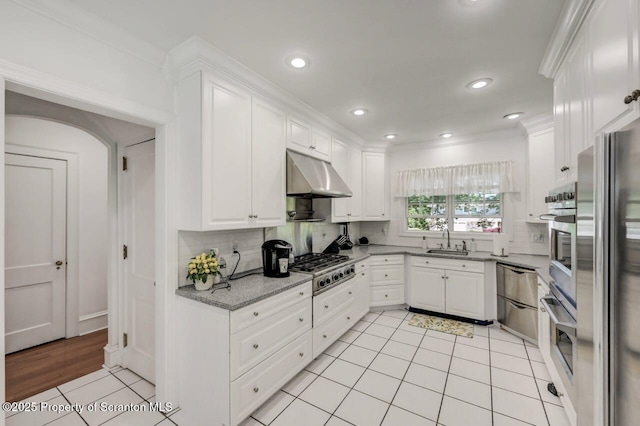 212 Lake Scranton Rd, Scranton, PA 18505 - kitchen with under cabinet range hood, backsplash, white cabinets, light tile patterned flooring, and light stone countertops