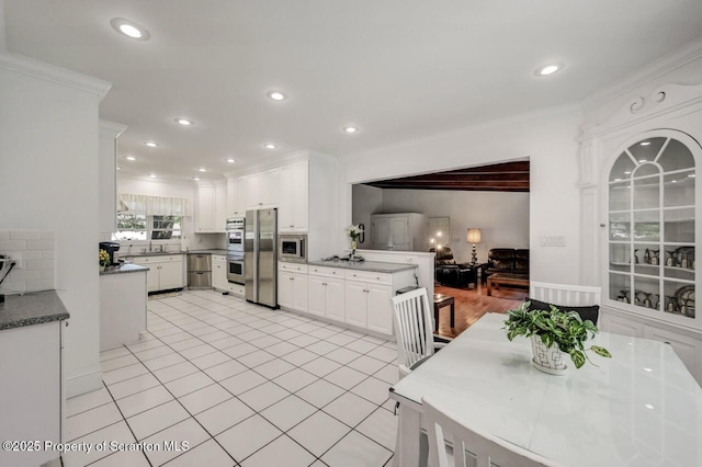 212 Lake Scranton Rd, Scranton, PA 18505 - kitchen with appliances with stainless steel finishes, white cabinets, recessed lighting, a peninsula, and decorative backsplash