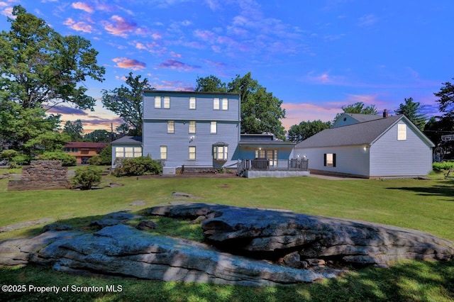 212 Lake Scranton Rd, Scranton, PA 18505 - back of house at dusk featuring a yard and a wooden deck
