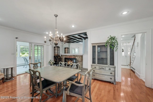 212 Lake Scranton Rd, Scranton, PA 18505 - dining space with a chandelier, crown molding, light wood-type flooring, recessed lighting, and a stone fireplace
