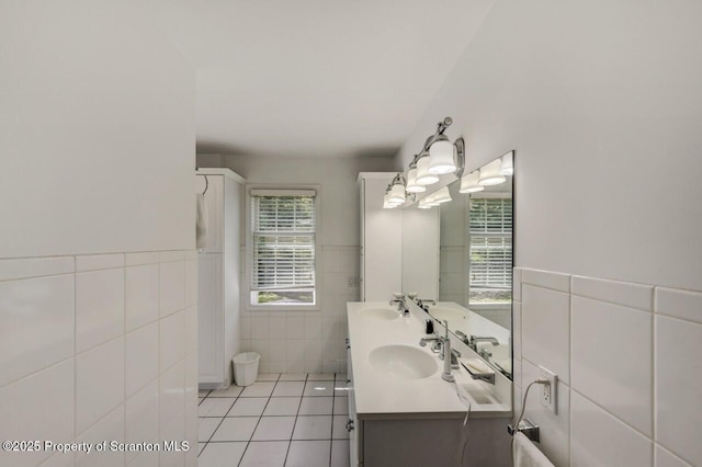 212 Lake Scranton Rd, Scranton, PA 18505 - full bathroom with tile walls, double vanity, tile patterned flooring, and wainscoting