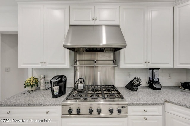 212 Lake Scranton Rd, Scranton, PA 18505 - kitchen with ventilation hood, white cabinetry, cooktop, and decorative backsplash