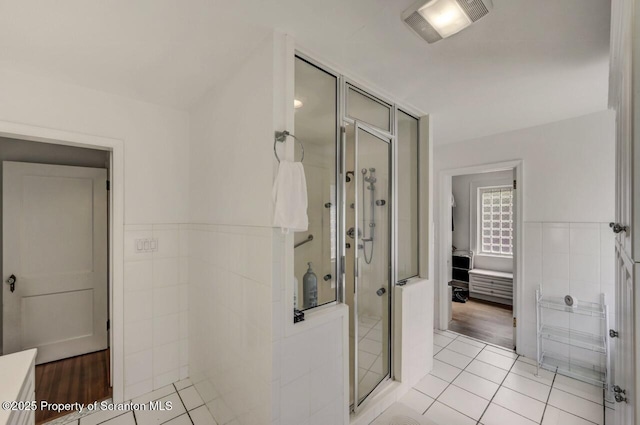 212 Lake Scranton Rd, Scranton, PA 18505 - bathroom with a shower stall, tile walls, tile patterned flooring, and a wainscoted wall