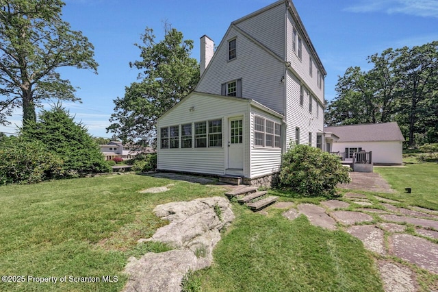 212 Lake Scranton Rd, Scranton, PA 18505 - rear view of property featuring a chimney, a lawn, and a sunroom
