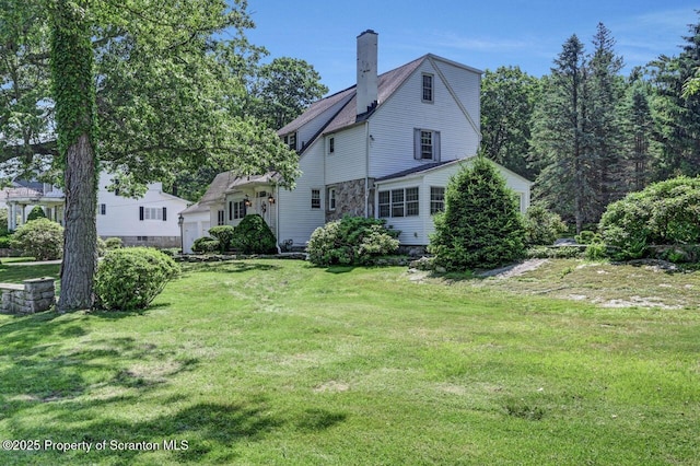 212 Lake Scranton Rd, Scranton, PA 18505 - rear view of house with a chimney and a lawn