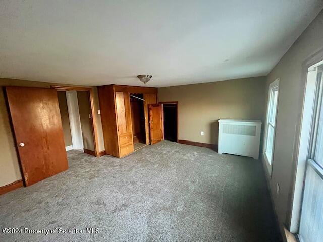 unfurnished bedroom featuring light carpet