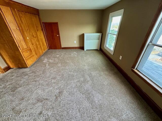 unfurnished bedroom featuring light colored carpet