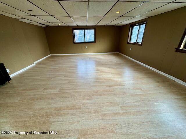 unfurnished room with a wealth of natural light and a drop ceiling