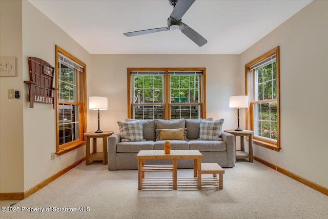 86 Paupack Point Rd, Hawley, PA 18428 - living room featuring healthy amount of natural light, baseboards, a ceiling fan, and light carpet