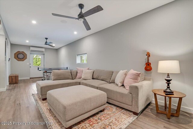 86 Paupack Point Rd, Hawley, PA 18428 - living room with a wall unit AC, a ceiling fan, light wood finished floors, recessed lighting, and baseboards