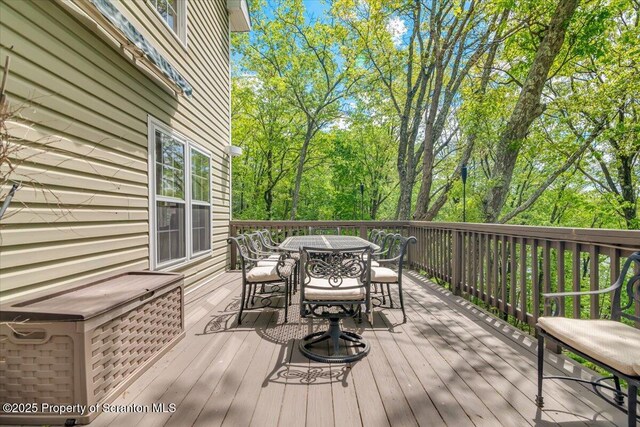 86 Paupack Point Rd, Hawley, PA 18428 - wooden deck featuring outdoor dining space and view of scattered trees