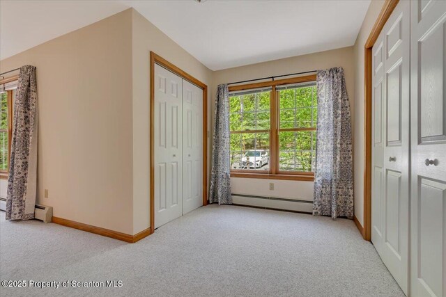 86 Paupack Point Rd, Hawley, PA 18428 - unfurnished bedroom featuring carpet, a baseboard radiator, baseboards, and a closet