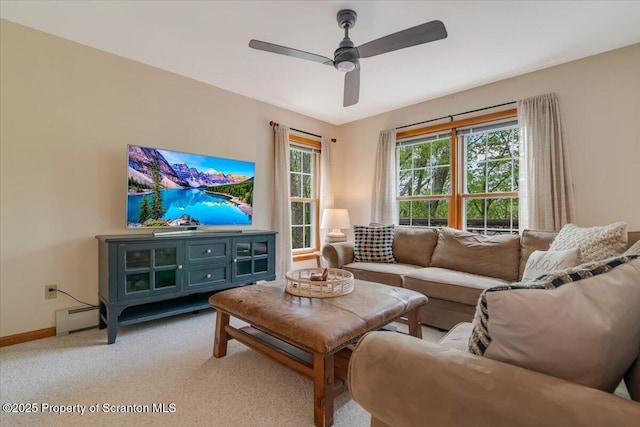 86 Paupack Point Rd, Hawley, PA 18428 - living area with a baseboard heating unit, light carpet, ceiling fan, and baseboards