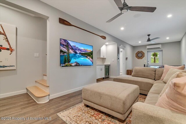 86 Paupack Point Rd, Hawley, PA 18428 - living area with a wall mounted AC, a ceiling fan, wood finished floors, beverage cooler, and recessed lighting
