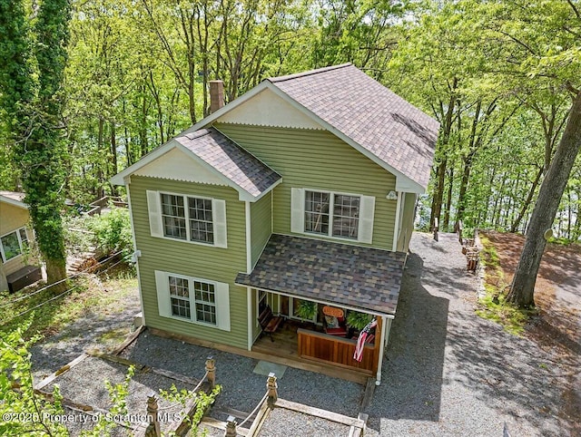 86 Paupack Point Rd, Hawley, PA 18428 - view of front of property with a shingled roof, a chimney, covered porch, and a wooded view