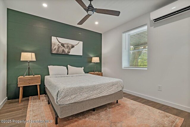 86 Paupack Point Rd, Hawley, PA 18428 - bedroom featuring a wall mounted air conditioner, baseboards, wood finished floors, recessed lighting, and a ceiling fan