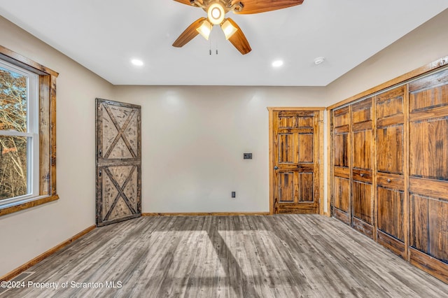 spare room with ceiling fan and wood-type flooring