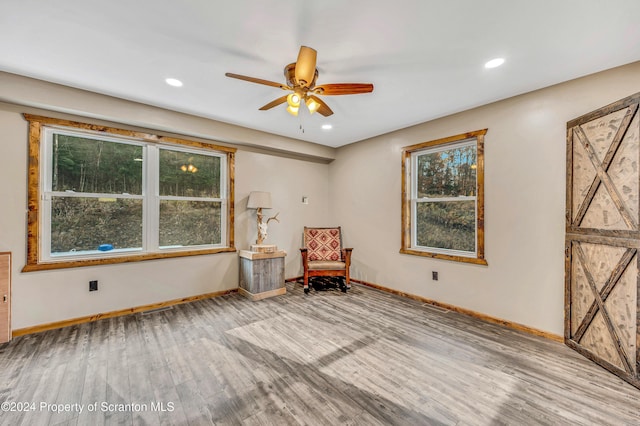 unfurnished room with ceiling fan and light hardwood / wood-style floors