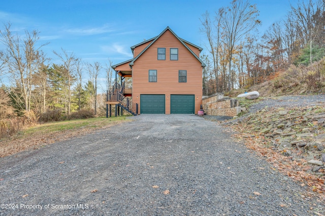 view of home's exterior with a garage and a deck