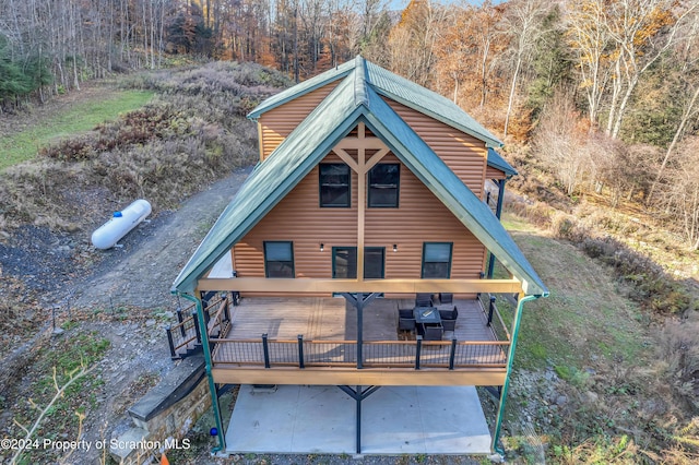 rear view of property featuring a deck