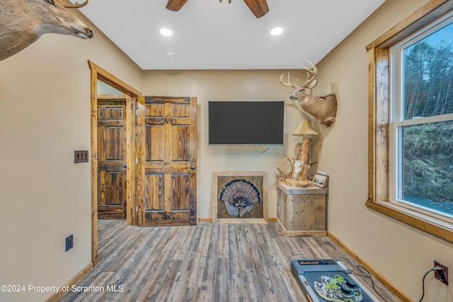 unfurnished living room featuring hardwood / wood-style flooring and ceiling fan