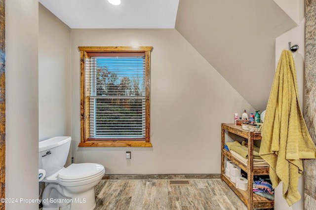 bathroom featuring vaulted ceiling and toilet