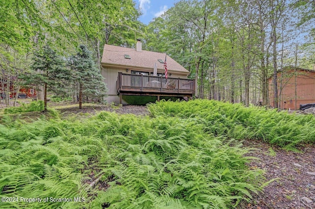 back of property featuring a wooden deck