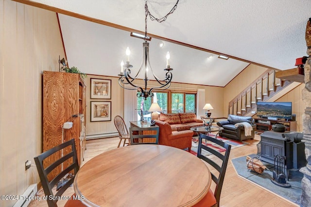 dining area with light hardwood / wood-style floors, lofted ceiling, a textured ceiling, and a baseboard radiator