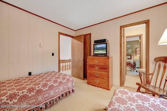 carpeted bedroom with a textured ceiling, crown molding, and wooden walls