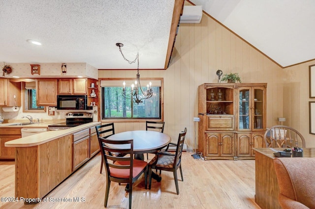 kitchen featuring light wood-type flooring, stainless steel range with electric stovetop, vaulted ceiling, decorative light fixtures, and a notable chandelier