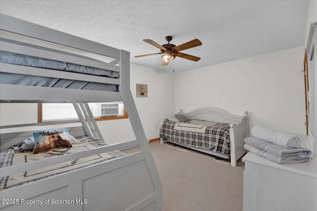 carpeted bedroom with ceiling fan, cooling unit, and a textured ceiling