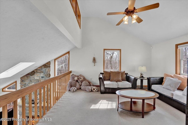 living room featuring carpet, plenty of natural light, high vaulted ceiling, and ceiling fan