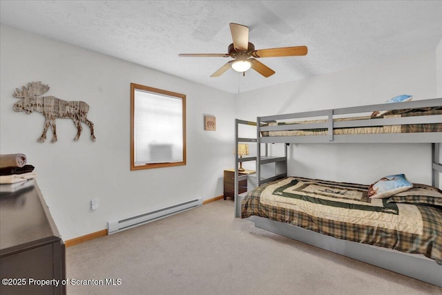 carpeted bedroom featuring a textured ceiling, a baseboard radiator, a ceiling fan, and baseboards