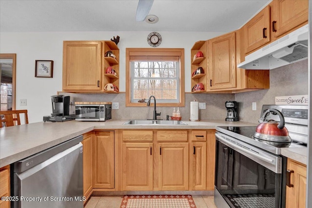 kitchen with tasteful backsplash, stainless steel appliances, under cabinet range hood, open shelves, and a sink