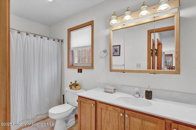 bathroom featuring curtained shower, vanity, and toilet