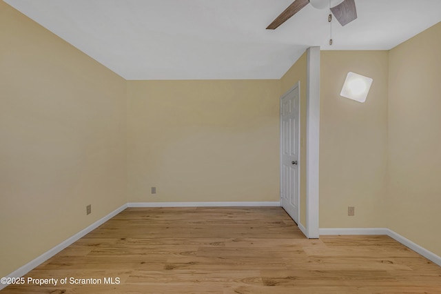 unfurnished room with light wood finished floors, a ceiling fan, and baseboards