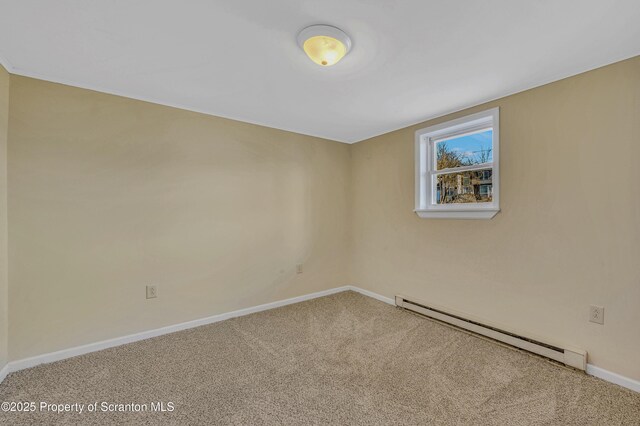 spare room featuring baseboards, carpet floors, and baseboard heating