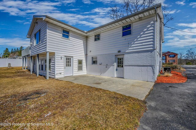 back of property featuring a patio, fence, and brick siding