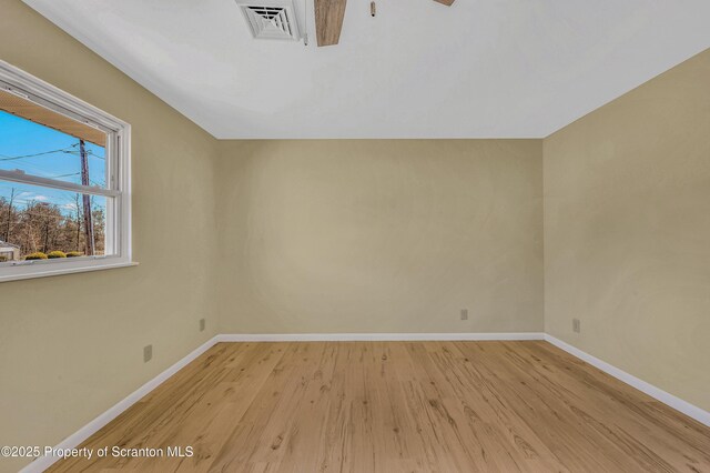 interior space featuring visible vents, light wood-style flooring, and baseboards