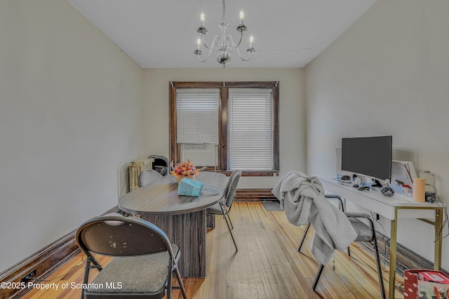 office with cooling unit, an inviting chandelier, and light wood-type flooring