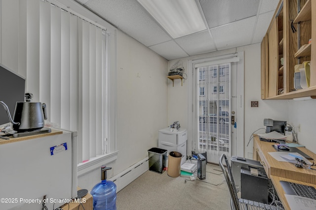 office with a drop ceiling and a baseboard heating unit