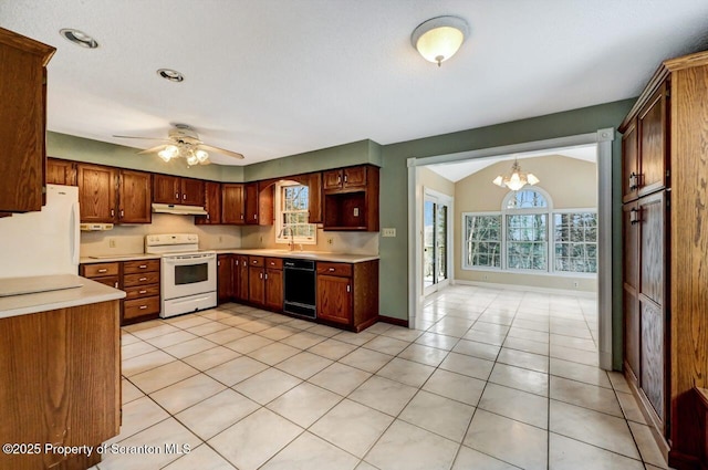 kitchen with white appliances, light tile patterned floors, lofted ceiling, ceiling fan with notable chandelier, and sink