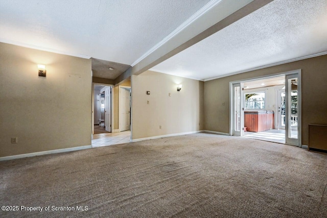 spare room with a textured ceiling, light colored carpet, and crown molding