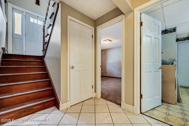 stairs featuring carpet flooring