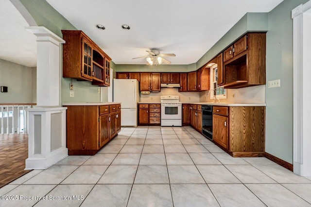 kitchen featuring white appliances, light tile patterned floors, ornate columns, ceiling fan, and sink