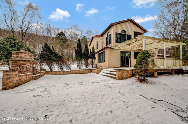 snow covered house with a pergola